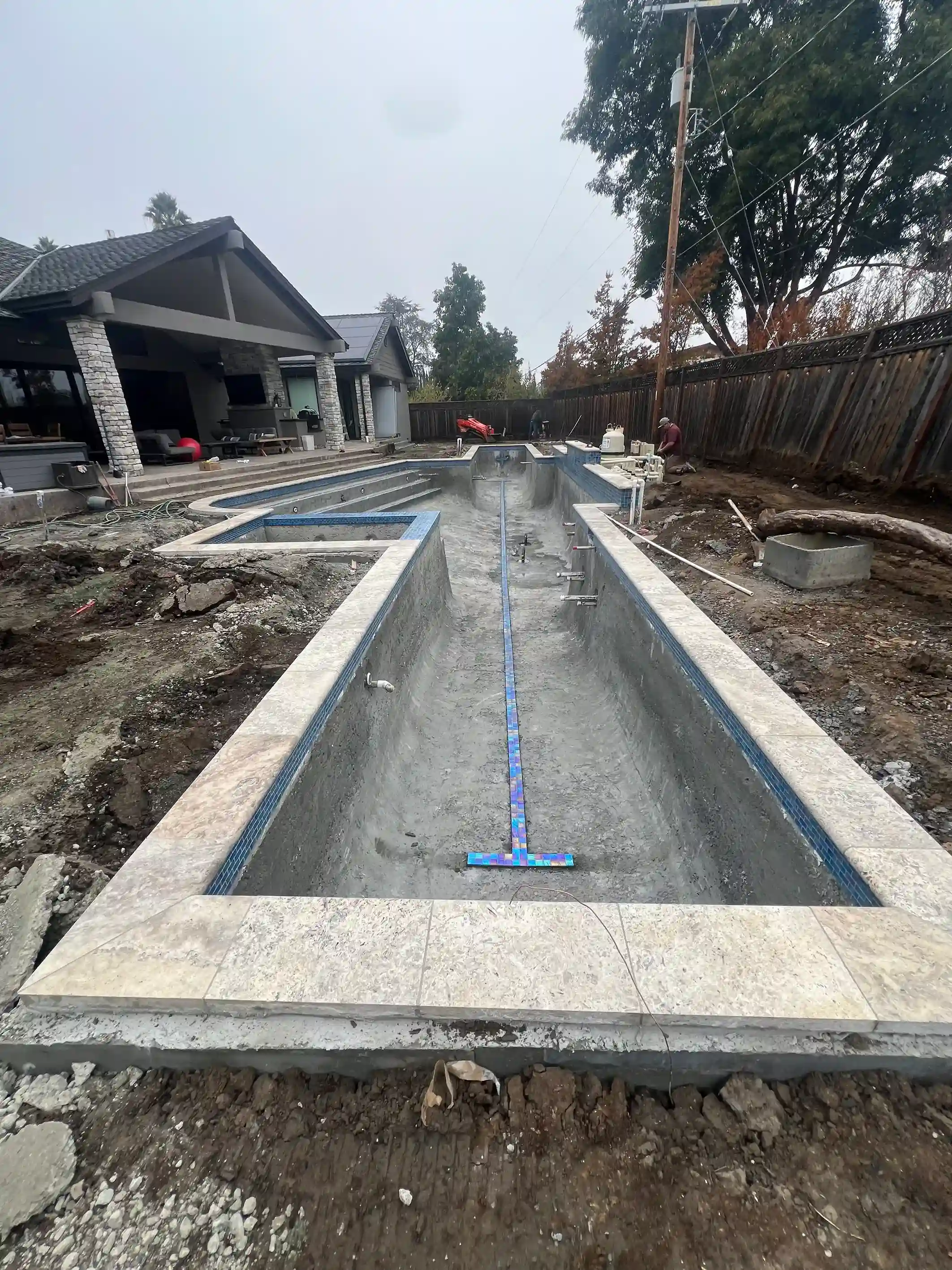 Custom pool installation with elegant tile details by Legendary Pools Inc.